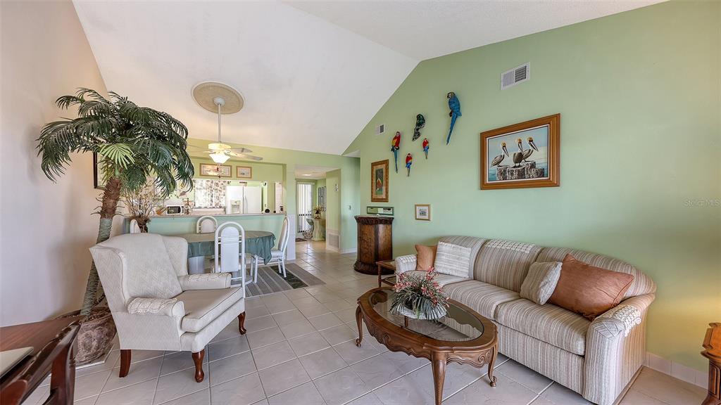 1196 Bird Bay Way, Unit 310 Venice, FL 34285 - Photo 10 of 37 a living room with furniture and a large window