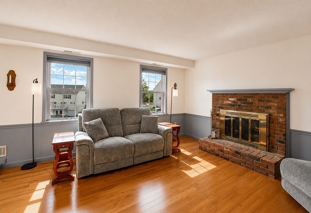 53 Century Way, Unit 53 Gardner, MA 01440 - Photo 4 of 22 a living room with furniture and a fireplace