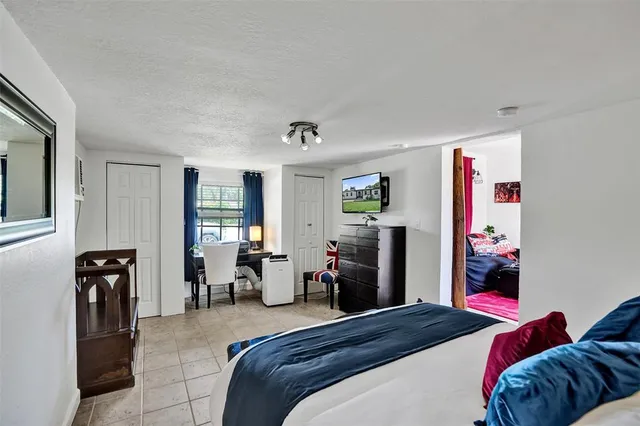 a bedroom with a bed and glass windows