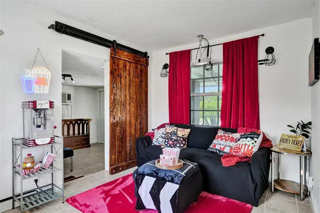 a living room with furniture and a chandelier