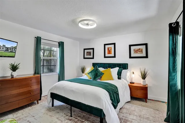 a bedroom with a bed and window