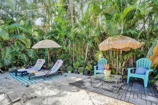 a view of a outdoor with a table and chairs under an umbrella