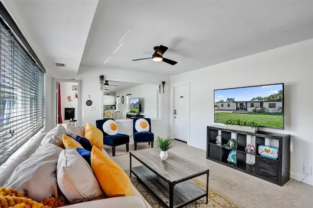 a living room with furniture and flat screen tv