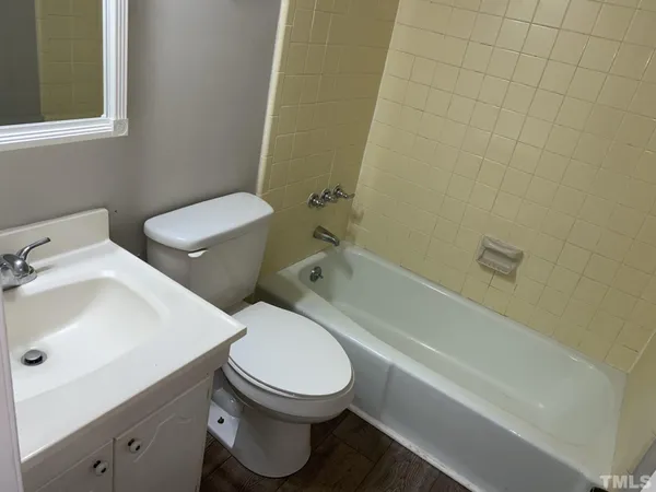 a white toilet sitting next to a bathroom sink