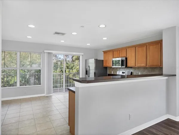 a large white kitchen with a large window