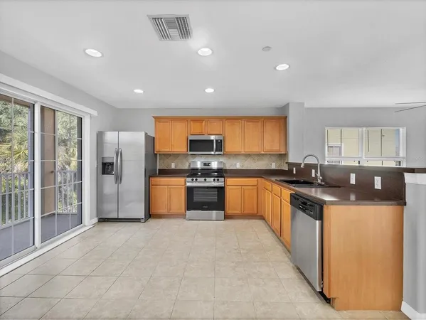 a large kitchen with stainless steel appliances lots of counter top space