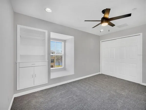 a view of empty room with ceiling fan
