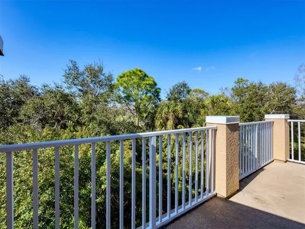 a balcony with trees in front of it