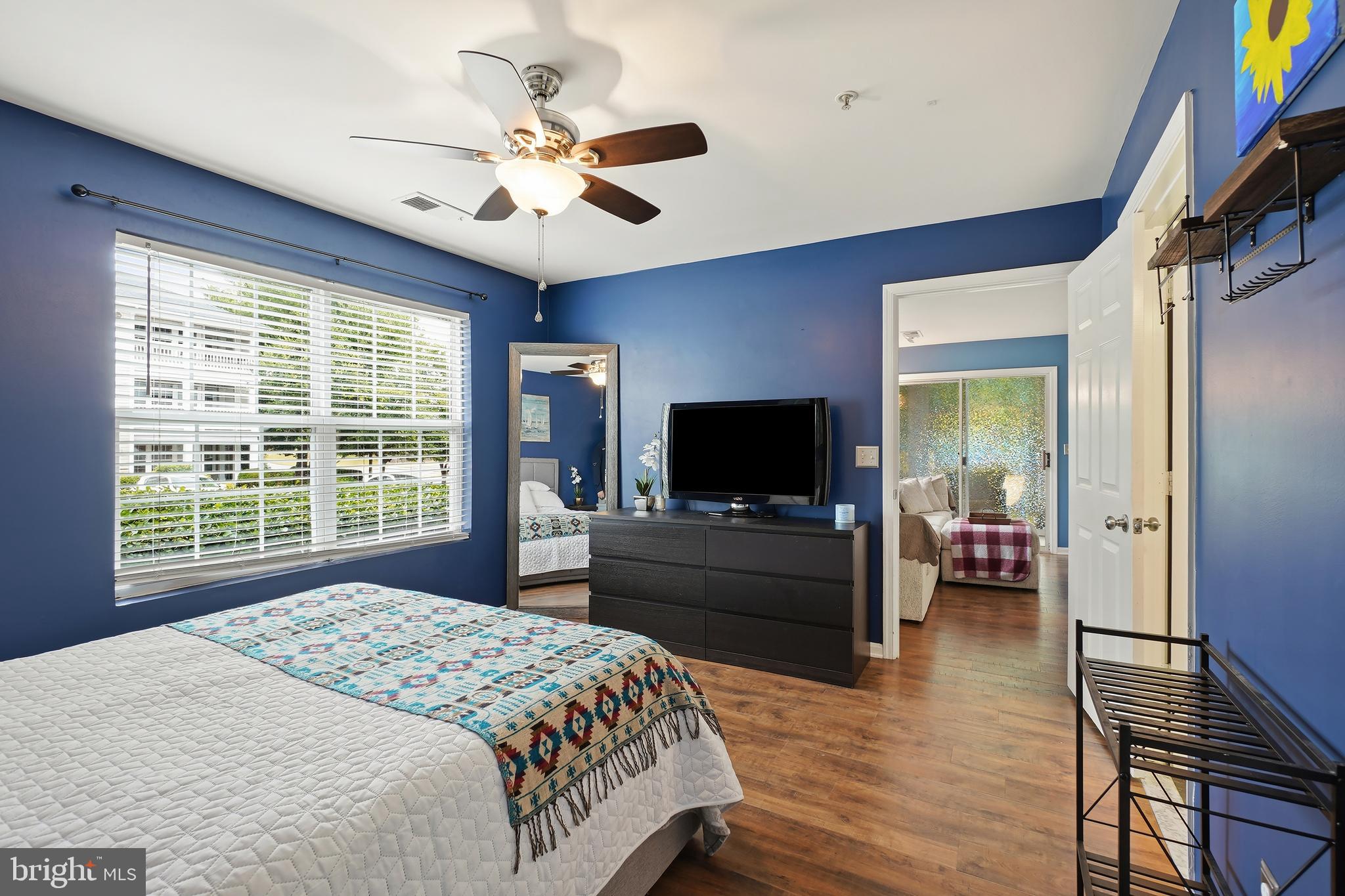 14151 Cuddy Loop, Unit 101 Woodbridge, VA 22193 - Photo 13 of 45 a bedroom with a bed and a flat screen tv
