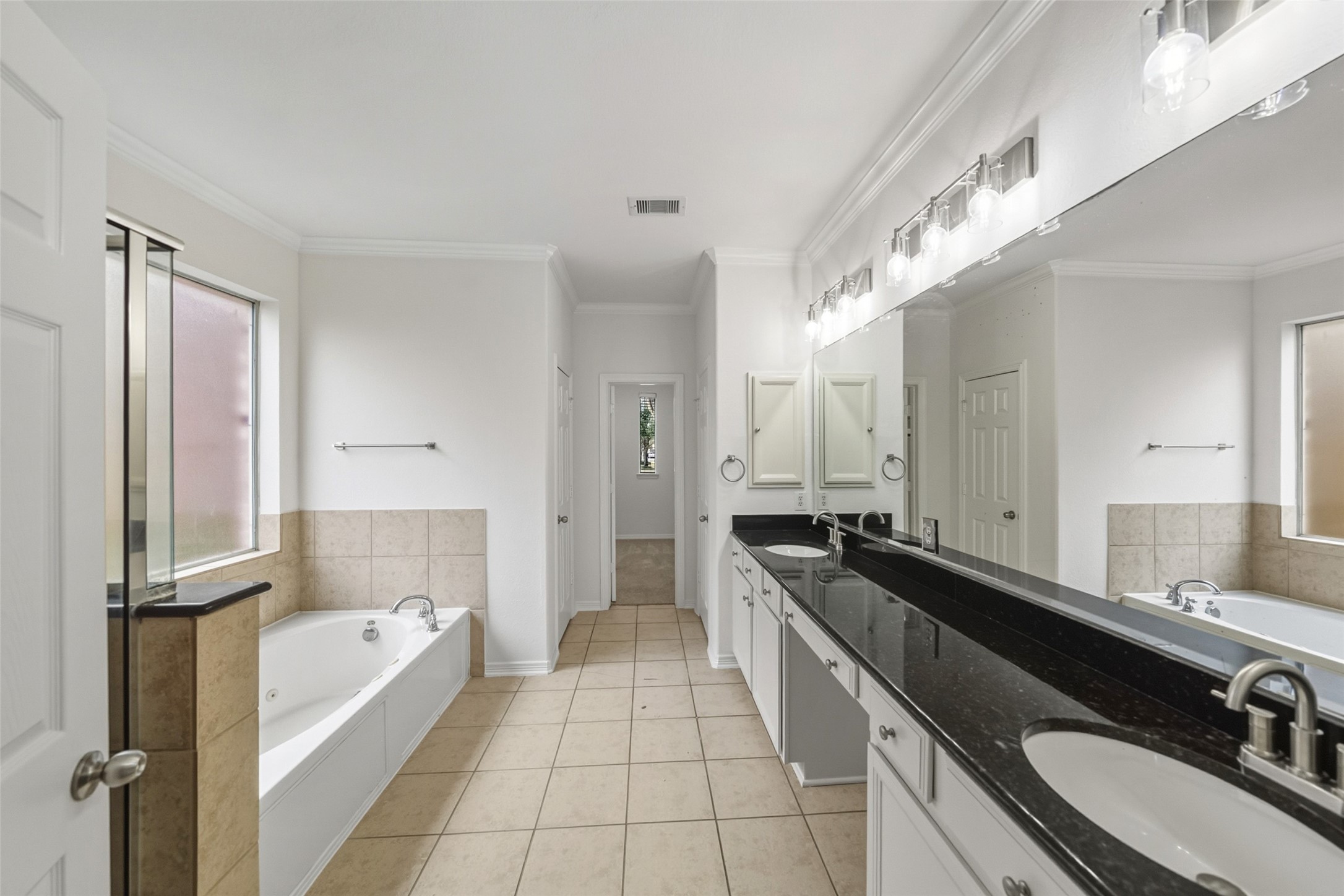 3103 Trail Ridge Drive Pearland, TX 77584 - Photo 18 of 35 a spacious bathroom with a granite countertop double vanity sink a mirror and a bathtub