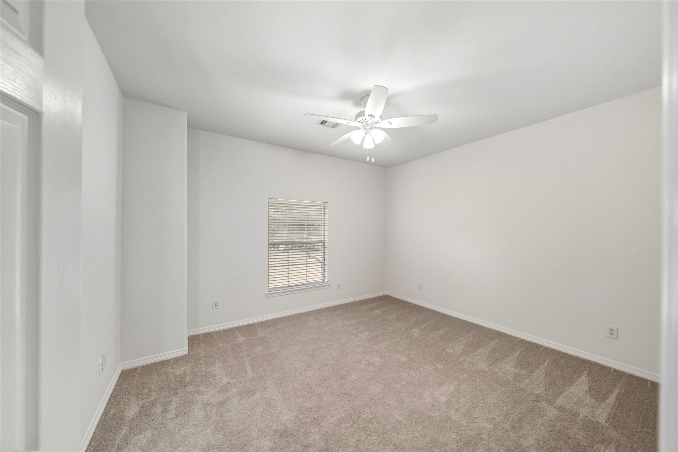 3103 Trail Ridge Drive Pearland, TX 77584 - Photo 21 of 35 an empty room with windows and ceiling fan