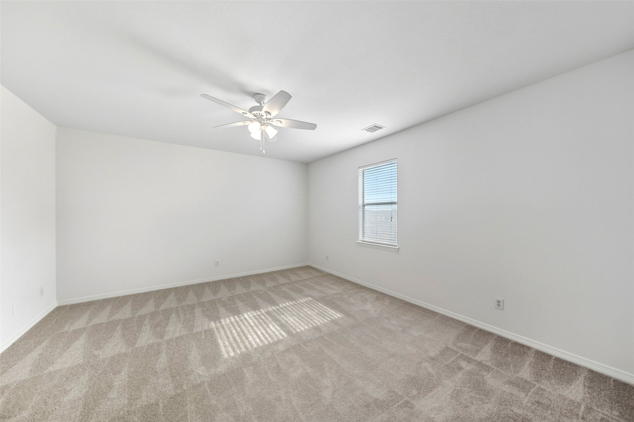 3103 Trail Ridge Drive Pearland, TX 77584 - Photo 24 of 35 an empty room with a chandelier fan and windows