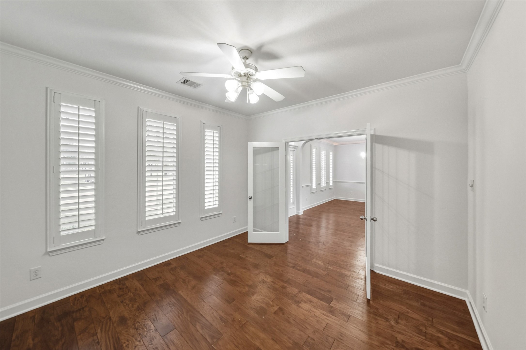 3103 Trail Ridge Drive Pearland, TX 77584 - Photo 3 of 35 an empty room with wooden floor fan and windows