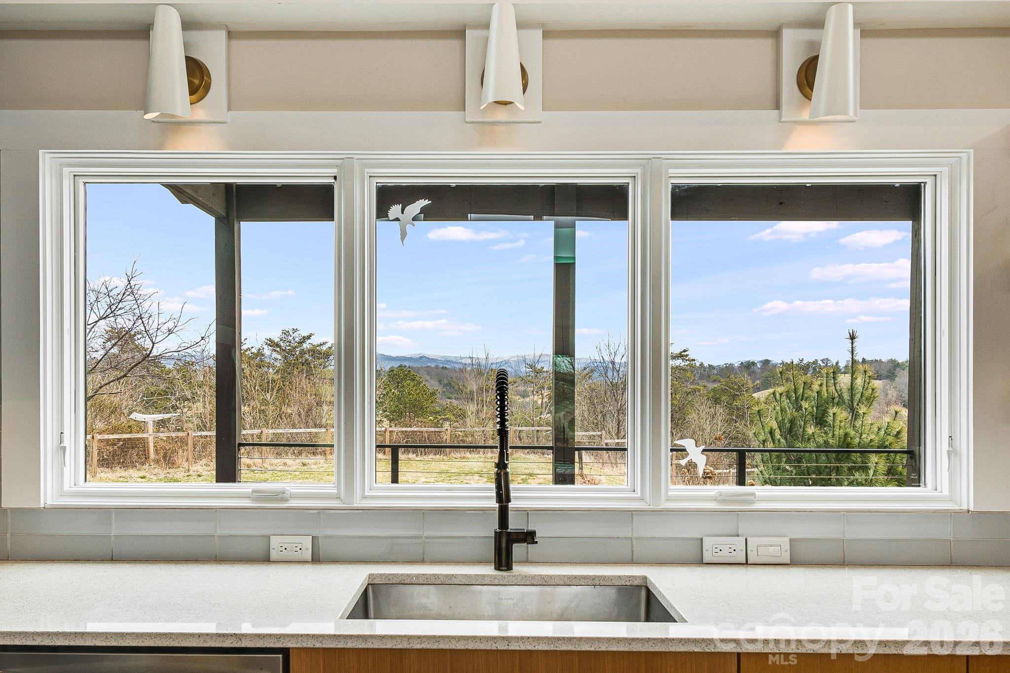76 Murray De Bruhl Road Alexander, NC 28701 - Photo 14 of 44 a living room with a large window and a floor to ceiling window