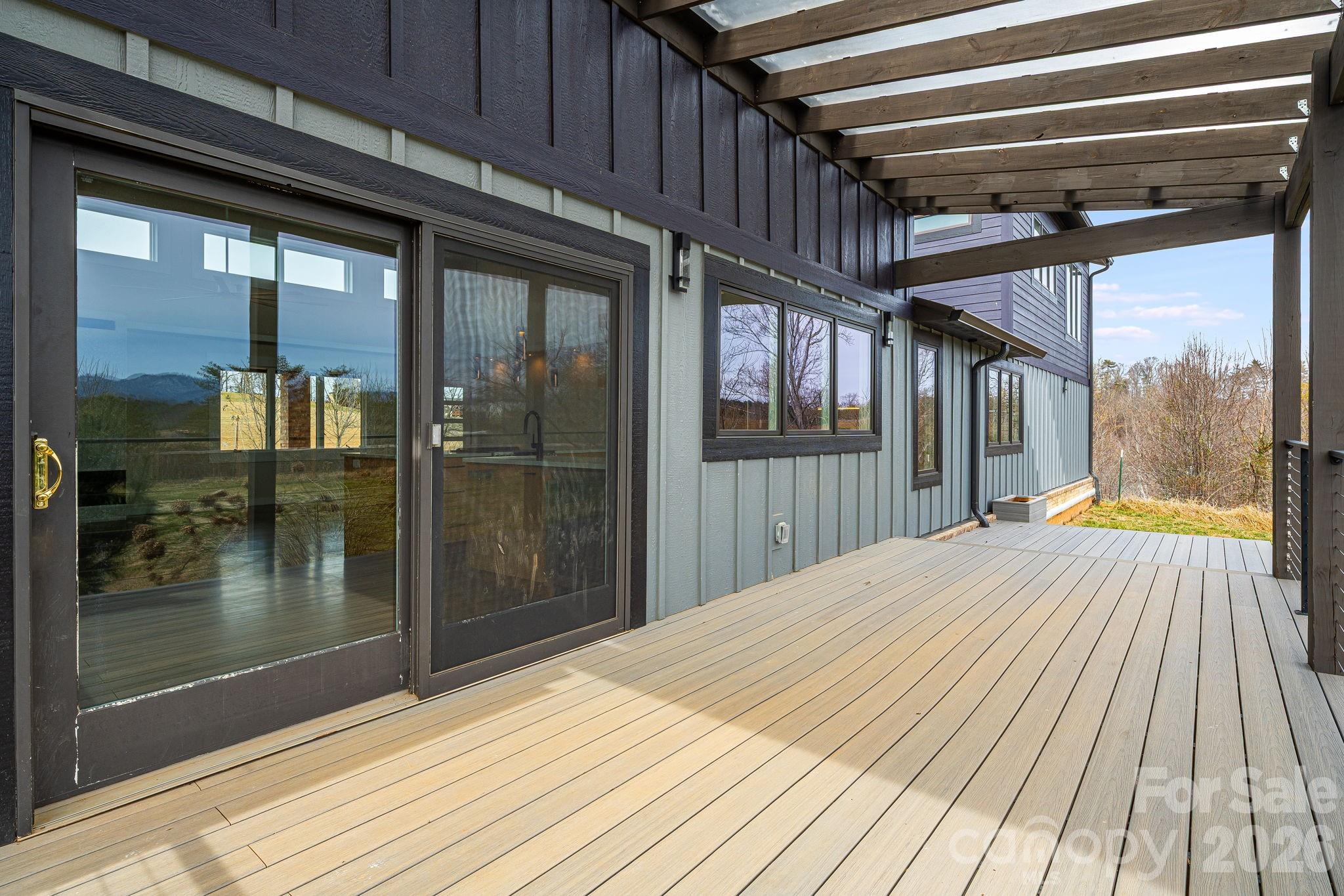 76 Murray De Bruhl Road Alexander, NC 28701 - Photo 15 of 44 a view of backyard with glass door and wooden floor