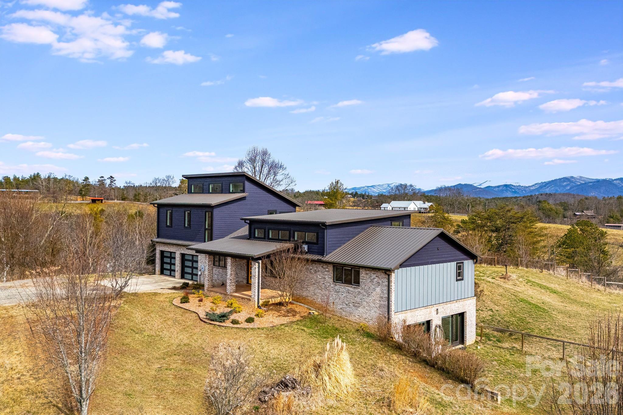 76 Murray De Bruhl Road Alexander, NC 28701 - Photo 2 of 44 a aerial view of a house with swimming pool and ocean view