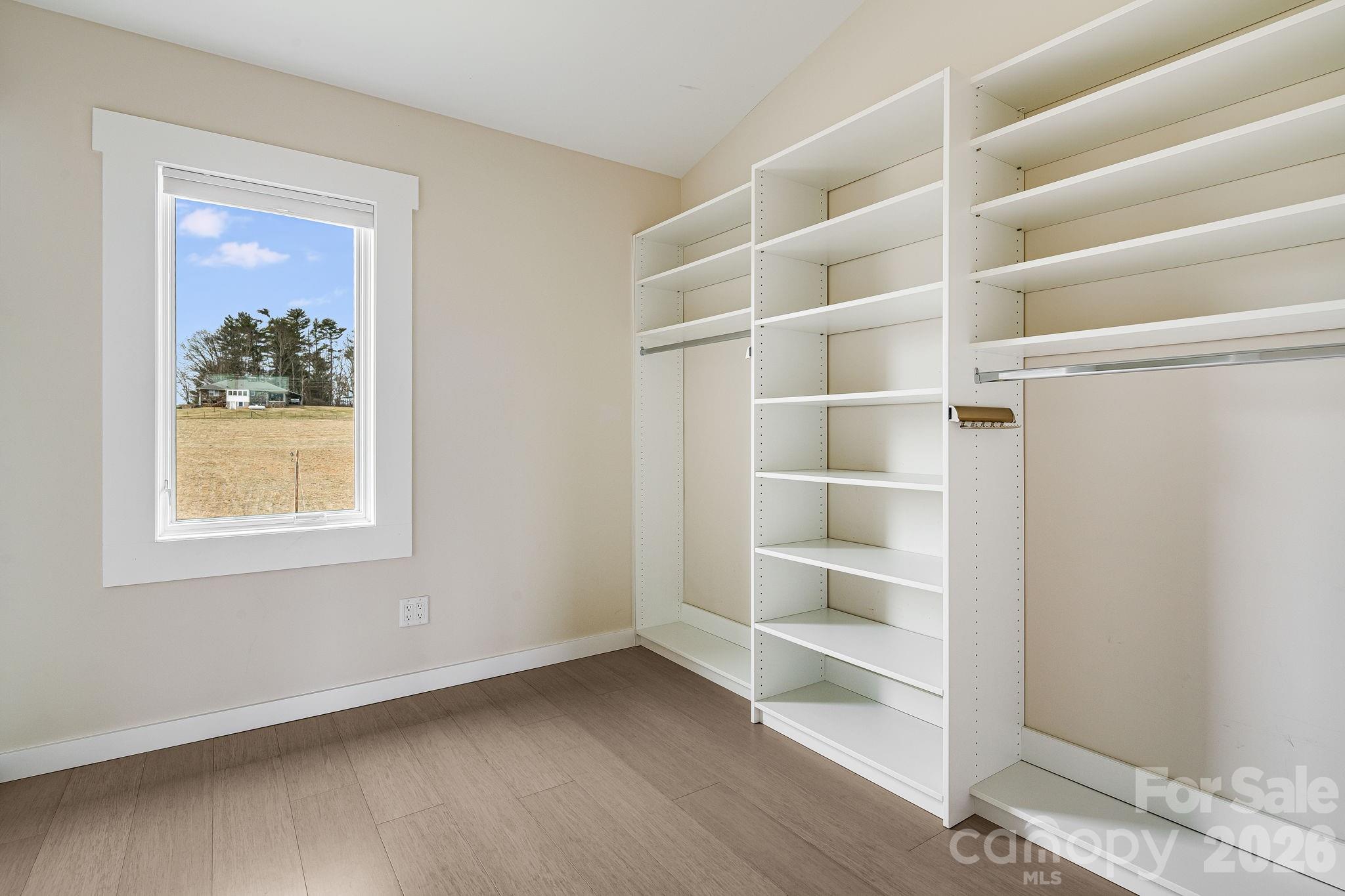 76 Murray De Bruhl Road Alexander, NC 28701 - Photo 24 of 44 a view of an empty room with a window and wooden floor