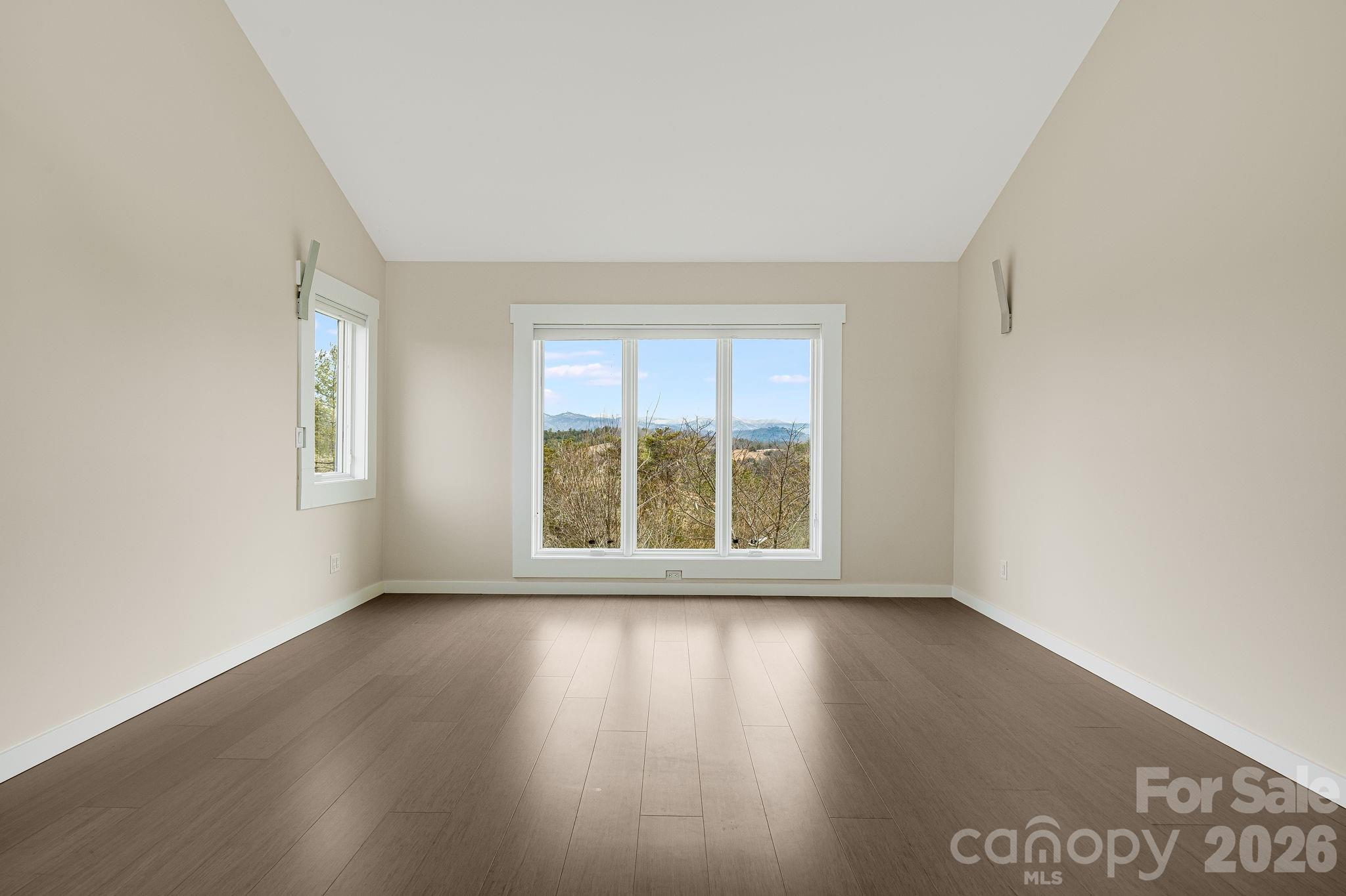 76 Murray De Bruhl Road Alexander, NC 28701 - Photo 26 of 44 an empty room with wooden floor and windows