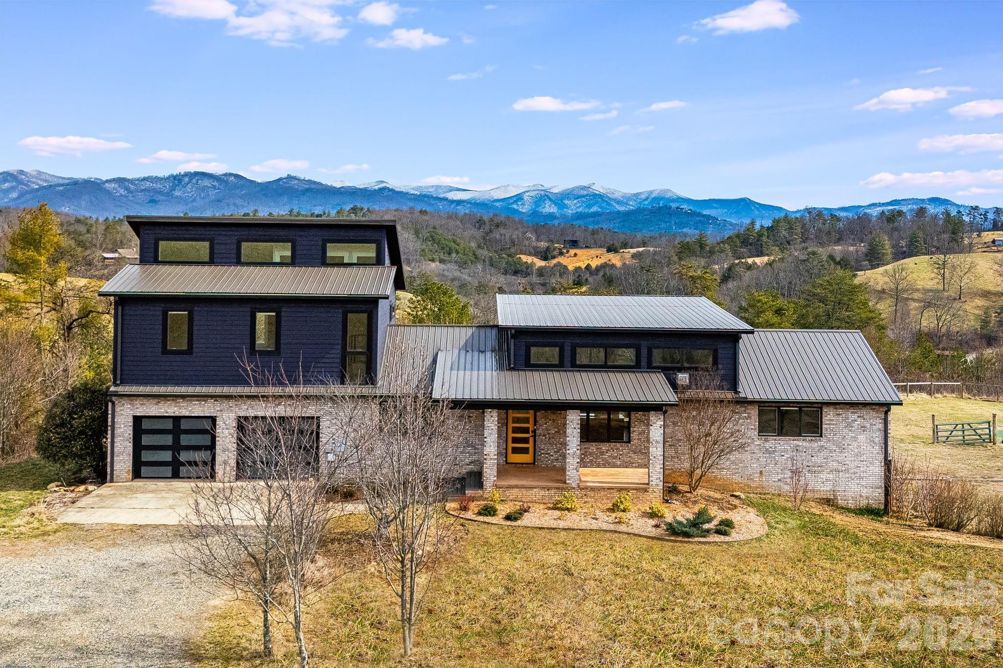 76 Murray De Bruhl Road Alexander, NC 28701 - Photo 5 of 44 a front view of a house with a yard and garage