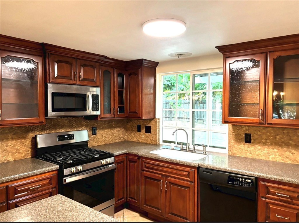 1164 Massachusetts Avenue Riverside, CA 92507 - Photo 7 of 14 a kitchen with granite countertop a sink and a stove top oven