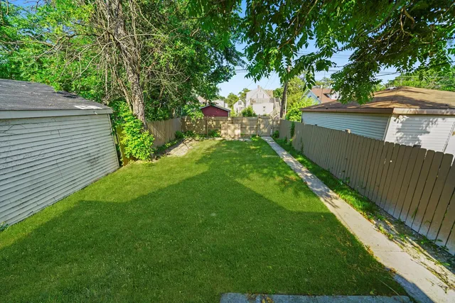 a view of a backyard with a tree