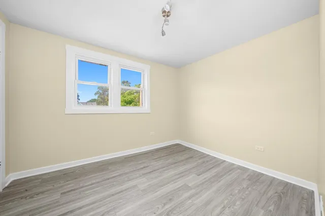 a view of a room with wooden floor and window