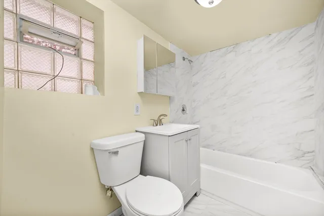 a bathroom with a sink a toilet and bathtub