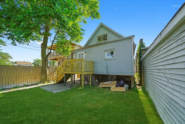 a view of a backyard with couches under an umbrella