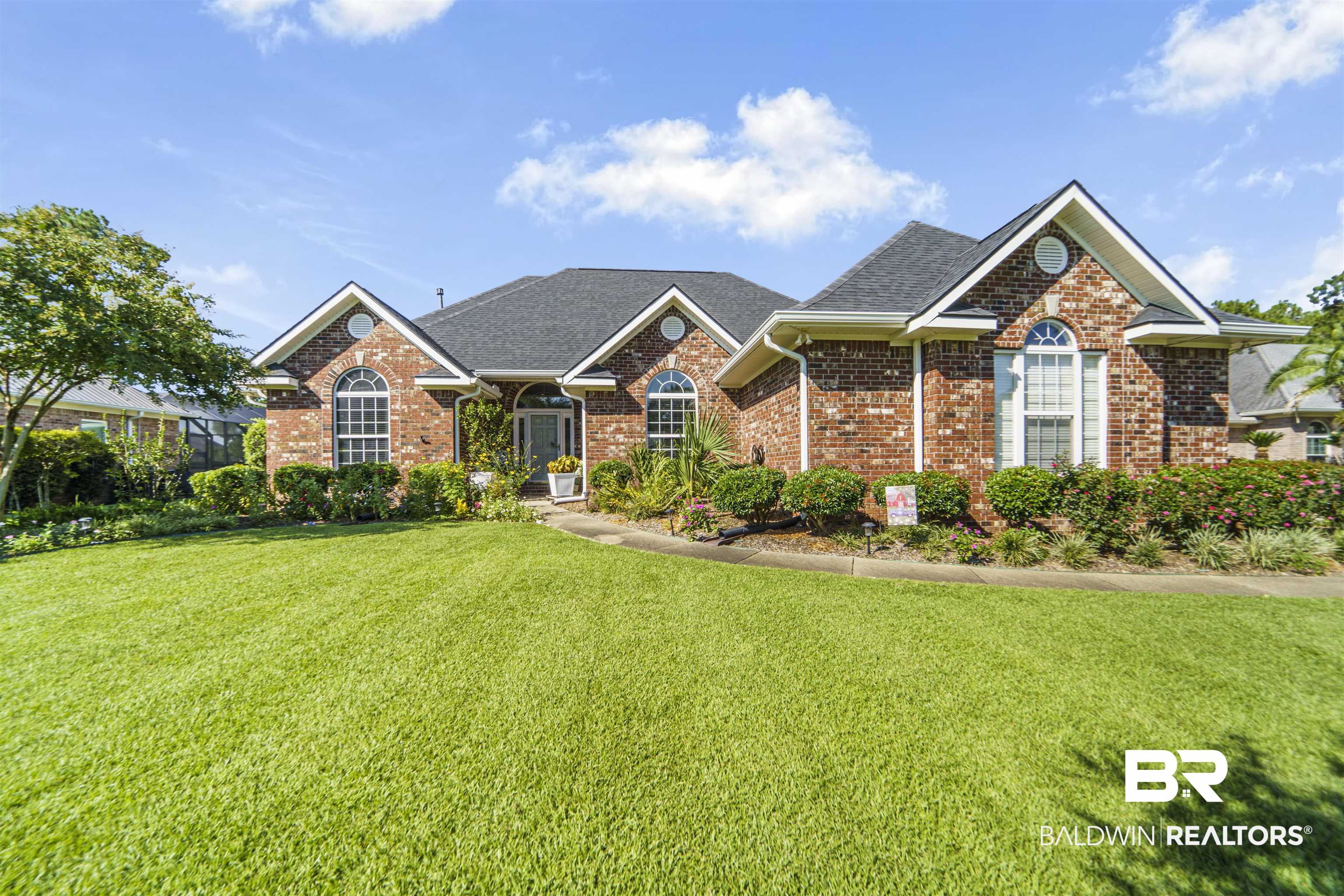 9505 Lakeview Drive Foley, AL 36535 - Photo 1 of 38 View of front of property with brick siding, a front yard, and a shingled roof