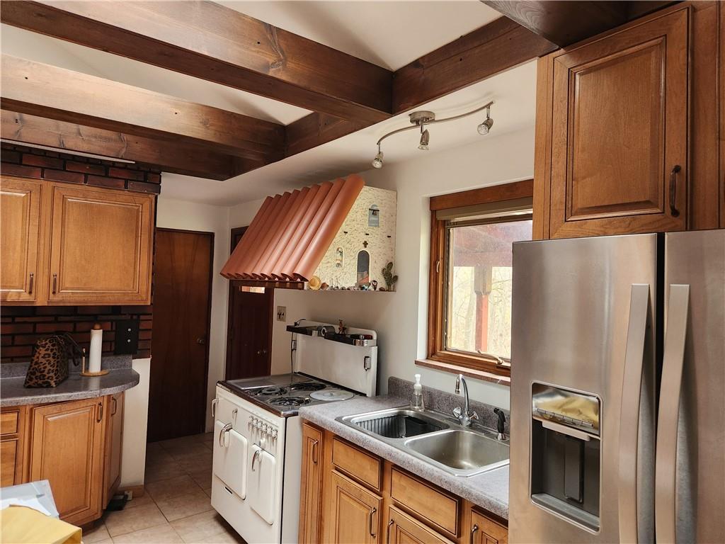 5330 Greensburg Road Apollo, PA 15613 - Photo 11 of 39 a kitchen with stainless steel appliances granite countertop a refrigerator a stove and a sink with wooden floors