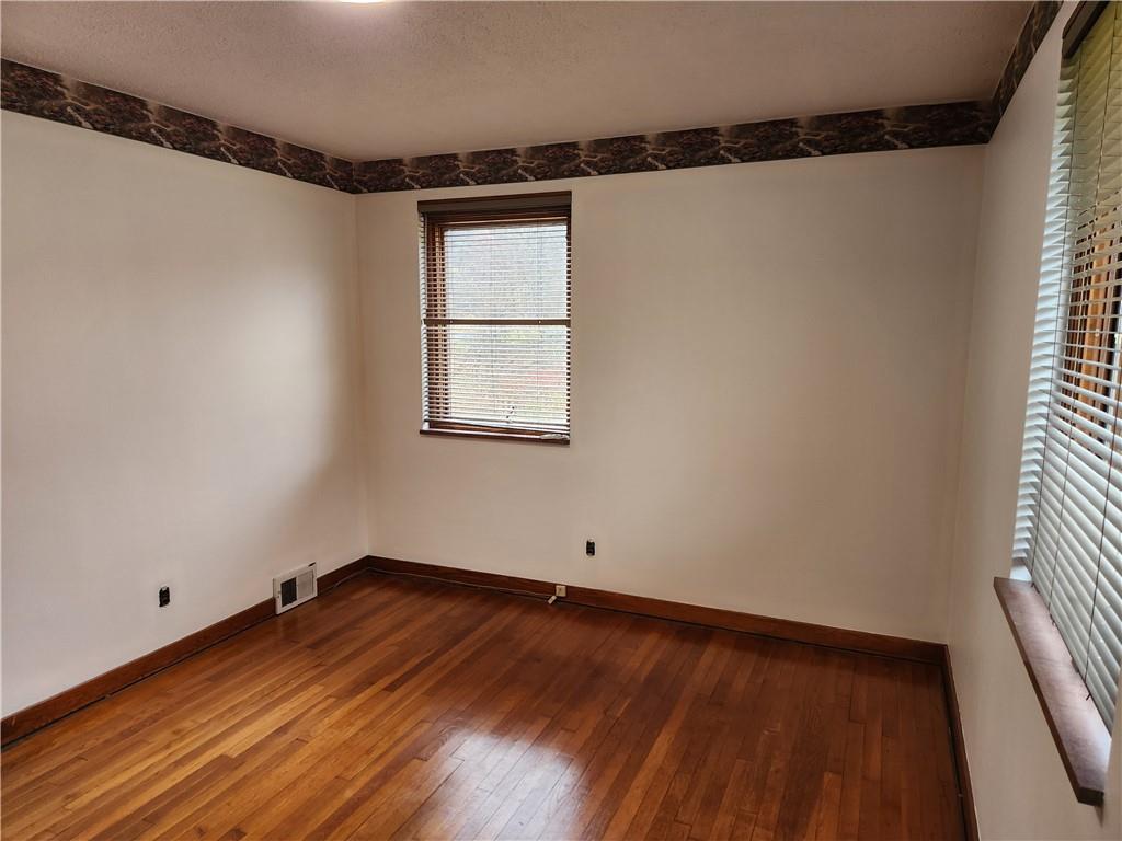 5330 Greensburg Road Apollo, PA 15613 - Photo 19 of 39 an empty room with wooden floor and windows