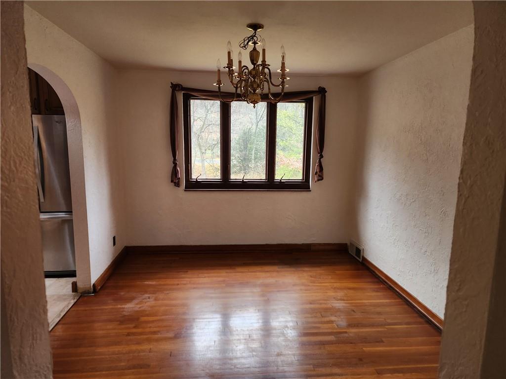 5330 Greensburg Road Apollo, PA 15613 - Photo 8 of 39 a view of an empty room with wooden floor and a window