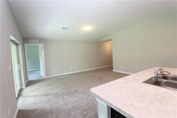 a kitchen with a sink cabinets and wooden floor