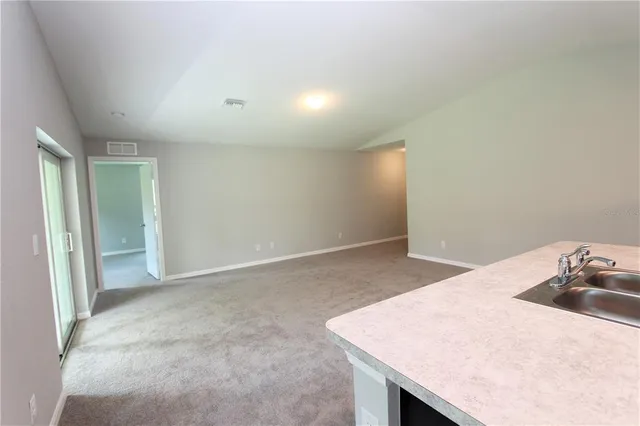 a kitchen with a sink cabinets and wooden floor