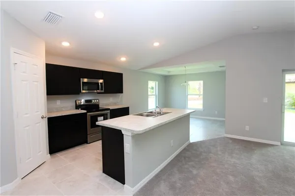 a kitchen with a sink stove and refrigerator