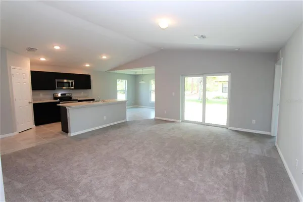 a view of a kitchen with a sink and a stove top oven