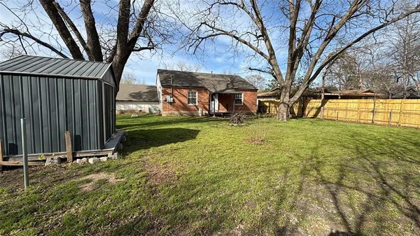 a view of a backyard with a large tree