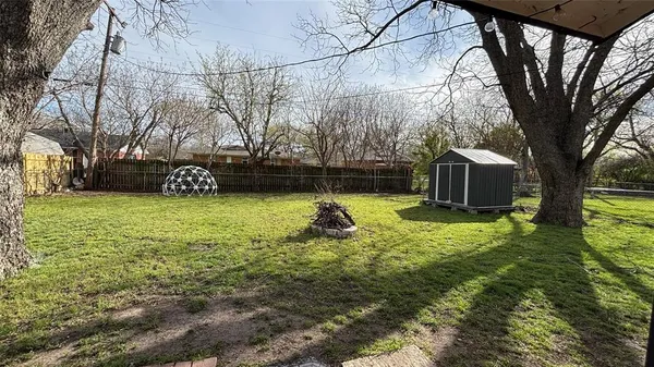 a view of a backyard with a garden and entertaining space