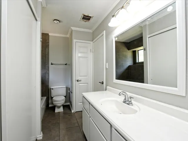 a bathroom with a sink double vanity and a toilet