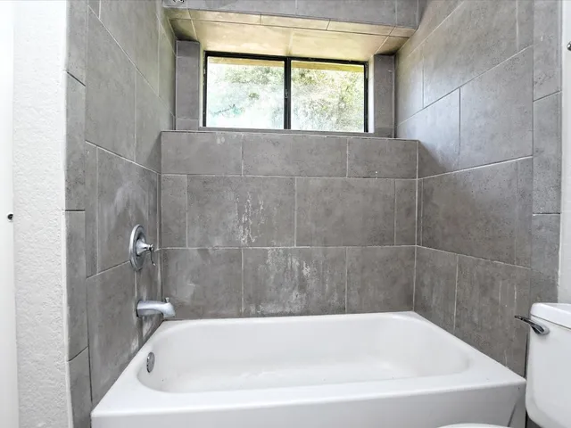 a white bath tub sitting next to a window