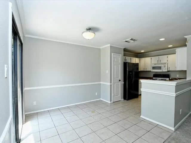 a kitchen with stainless steel appliances kitchen island granite countertop a refrigerator and a sink