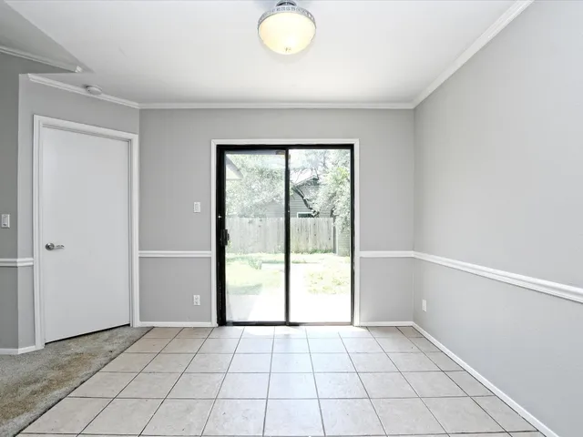 a view of an empty room with glass door