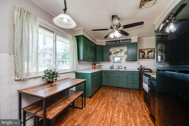 a kitchen with stainless steel appliances a table chairs and a chandelier