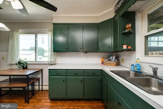 a kitchen with a sink cabinets and a window