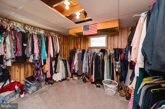 a view of walk in closet with clothes