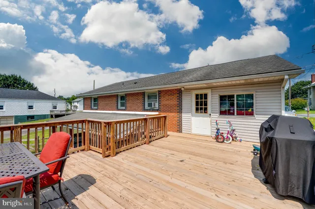 a view of a house with wooden deck