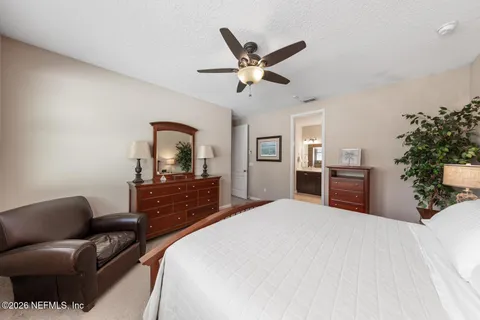 a bedroom with a large bed and a chandelier