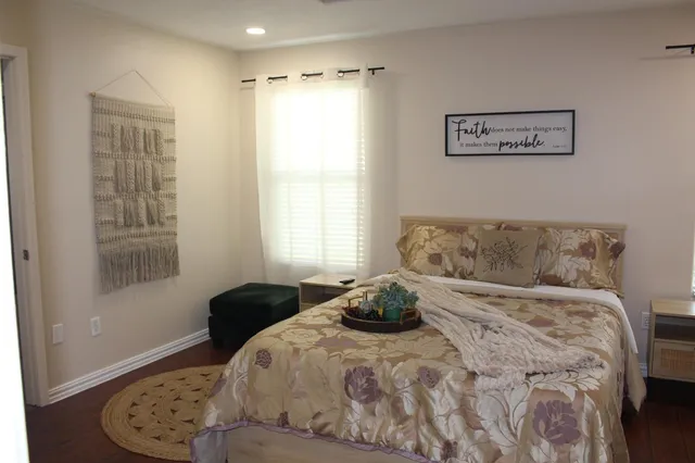 a bedroom with a bed and a window