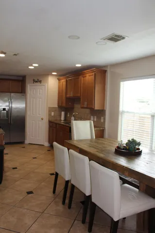 a kitchen with kitchen island a sink counter and chairs