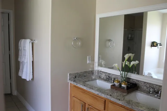 a bathroom with a granite countertop sink and a mirror